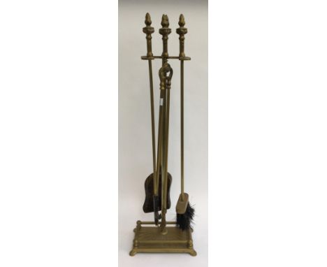 A set of fire tools with stand to include brush, poker, tongs, and shovel 