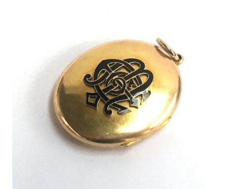 A Victorian yellow metal (tests as 9ct) and black enamel mourning pendant locket. Gross weight 21.6g 