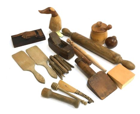 A mixed lot of wooden items to include treenware checkered darning mushroom; clothes pegs; butter pats; pointing finger woodb