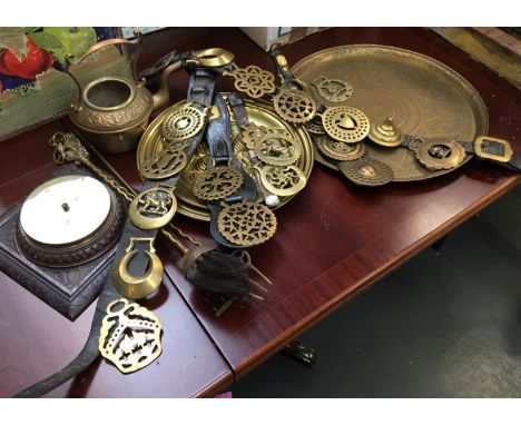 A mixed lot to include a quantity of leather mounted horse brasses, several brass trays, fire tools, barometer and a long han