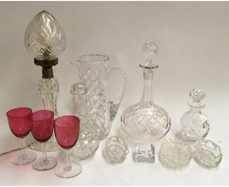 A mixed lot of cut glass items, to include table lamp, decanter, water jug, several small decanters, pin dishes and three cra