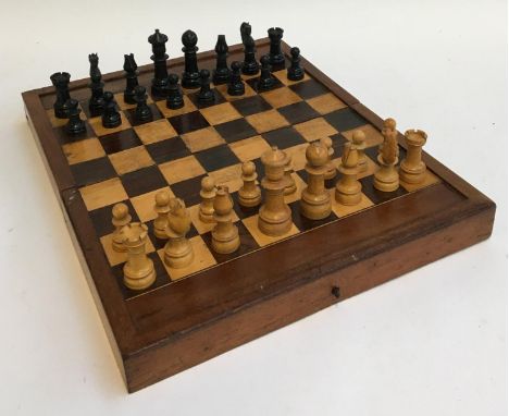 A wooden folding chess board containing complete chess set, with backgammon board within, 38cmW