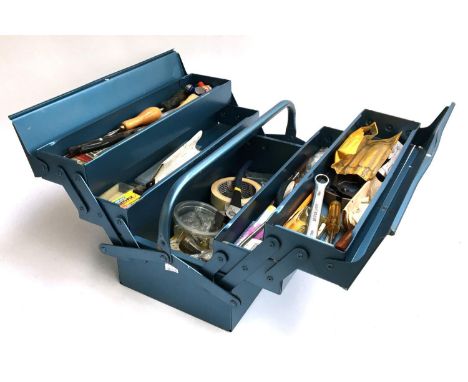 A metamorphic metal toolbox containing various tools, hammers, pliers, spanners etc 