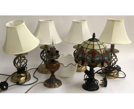 A set of four table lamps; together with a lamp with tiffany style shade and one other shade 