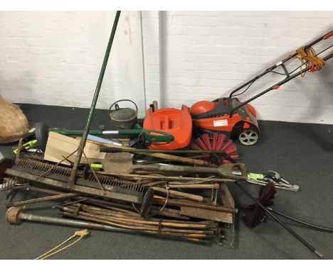 A quantity of vintage tools to include chimney sweeps, rake, strimmer, spade, watering can, shears, rodding, aerator, electri