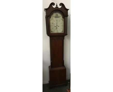 An oak cased longcase clock, broken pediment, painted dial, with Arabic numerals and two subsidiary dials, the door flanked b