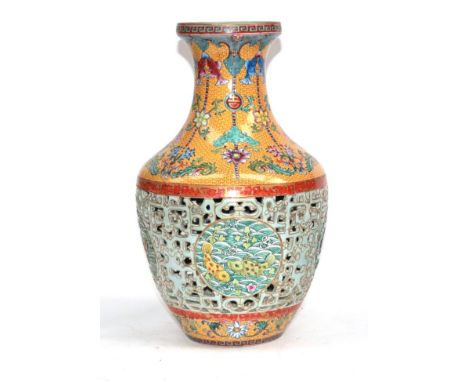 A Chinese Porcelain Reticulated Vase, Qianlong seal mark but not of the period, of baluster form, painted in famille rose ena