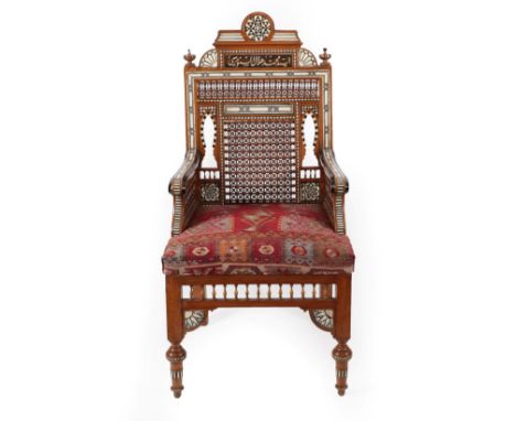 A Damascus Mother-of-Pearl and Bone Inlaid Ebonised Hardwood Throne Chair, late 19th century, the architectural cresting with