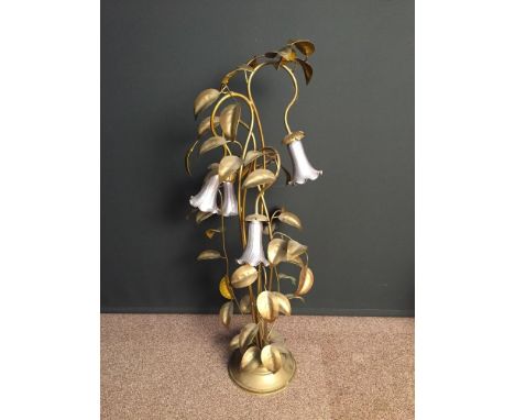 A Continental brass and ironwork floor standing lamp, in the Art Nouveau taste as foliate tendrils supporting bell shaped flo