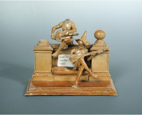 George Tinworth for Doulton Lambeth, an incredibly rare musical group, circa 1900, modelled as two figures sitting upon a wal