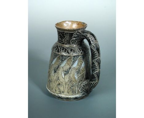 A Martin Brothers stoneware jug, with incised stylised leaf decoration, inscribed to the underside 'M18, R. W, Martin, London