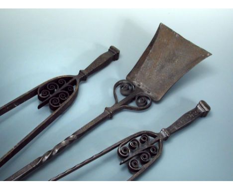 A set of Cotswold school wrought iron fire tools, comprising shovel and two sizes of tongs 90cm (35.5in) long  
