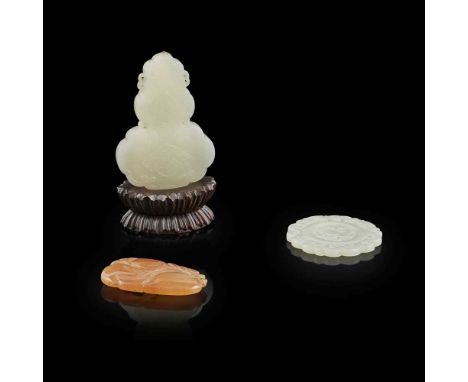                  comprising: a white jade in a double gourd form, carved with a symbol of shuangxi (happiness and marriage), 