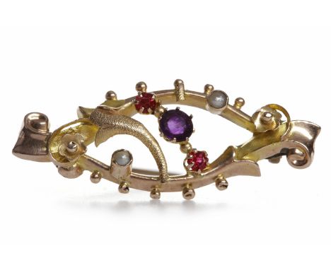 EDWARDIAN AMETHYST AND SEED PEARL BROOCH
the central round amethyst flanked by two red gems, in nine carat gold, 3.5cm long, 