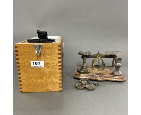 A cased hand compass and balance scale.
