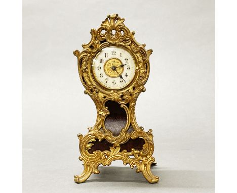 An early 20thC ornate ormolu mounted solid mahogany mantel clock, H. 19cm. Appears to be in working order but not tested.