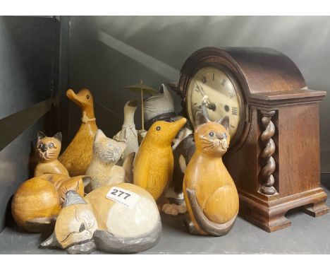An oak mantel clock and a group of animal figures.