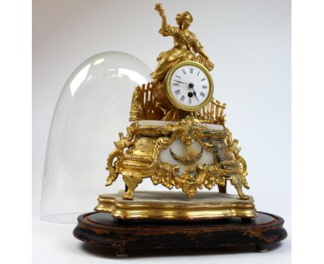 French gilt metal mantle clock with female holding flowers, circa late 19th / early 20th century, on stand, contained in orig