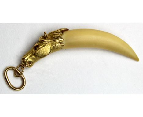 Yellow metal (tests 18ct) Horses Head with Ruby set eyes set with animal claw weight 9.5 grams 