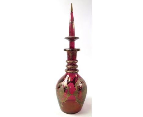 Large cranberry coloured glass decanter with stopper, ornate gilt decoration, possibly oriental, height 58.5cm approx. 