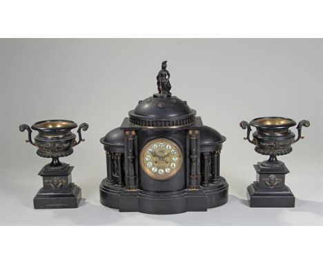 Victorian black slate mantle clock, of architectural form, surmounted with a figure above a dome and balusters, flanked by lo