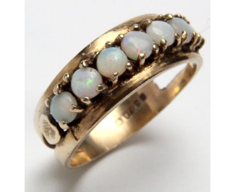 9ct Gold Ring set with a row of Opals size M weight 2.6 grams