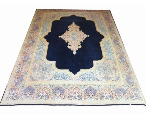 VINTAGE PERSIAN KIRMAN CARPET, 371cm x 272cm, pendant medallion on sapphire field within mirhab border. 