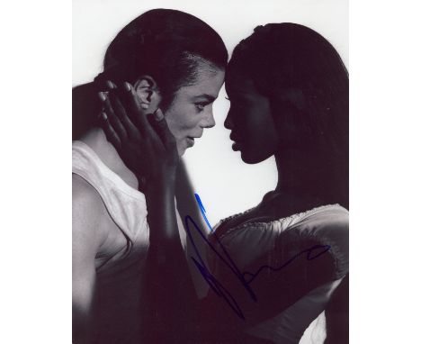CAMPBELL NAOMI: (1970- ) British Model. Signed 8 x 10 photograph of Campbell showing the model in a half-length warm pose, ho