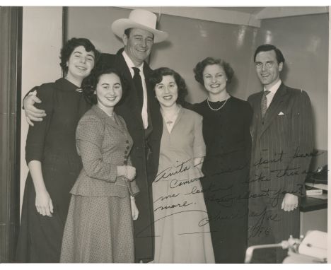 WAYNE JOHN: (1907-1979) American Actor, Academy Award winner. Signed and inscribed 10 x 8 photograph of Wayne standing in a f