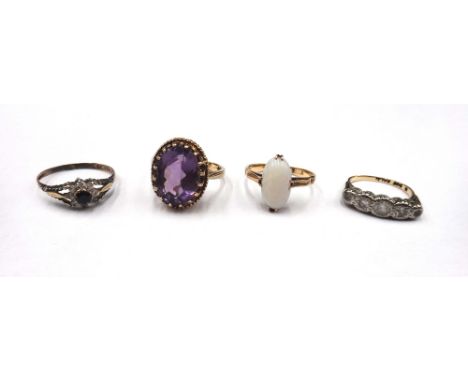 A gold ring, claw set with an oval opal, detailed 18, a 9ct gold ring, claw set with an oval cut amethyst, a gold and colourl