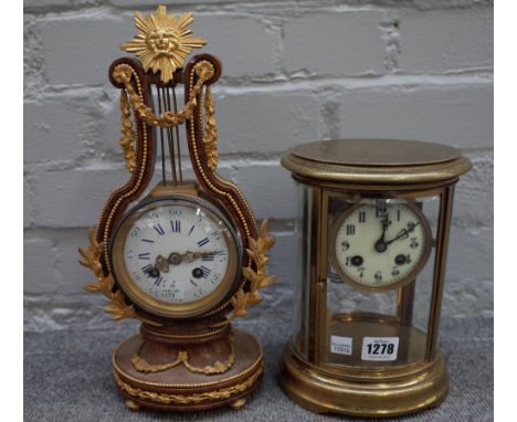A gilt brass cased, oval four glass mantel clock with enamel dial and two train movement, 22cm high, (faux mercury movement) 