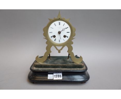 A French brass mantel clock with enamel dial detailed 'Hausburg Paris', 18cm high, a miniature brass and champlevé longcase c