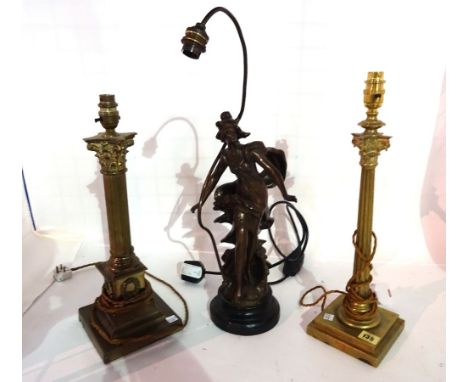 A gilt metal corinthium column shaped lamp, 40cm high another similar and a spelter figural lamp, (3).  S4M 