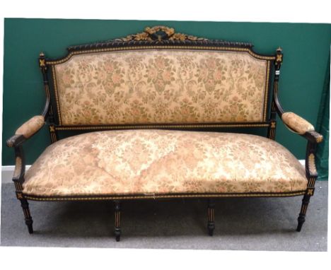 A 19th century parcel gilt ebonised open arm sofa, with flaming torch and quiver carved crest, above straight front seat, on 