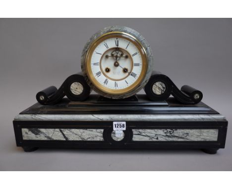 A Victorian black slate and marble inlaid mantel clock, with drum case enclosing a visible escapement detailed 'REED & SON MA