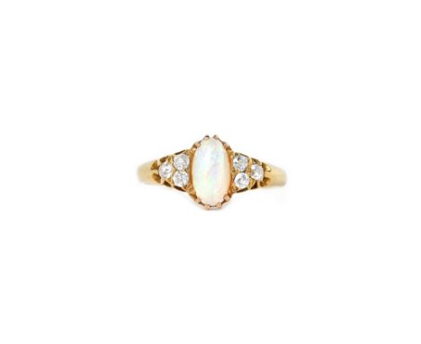 A gold, opal and diamond ring, claw set with the oval opal between diamond three stone shoulders, mounted with cushion shaped