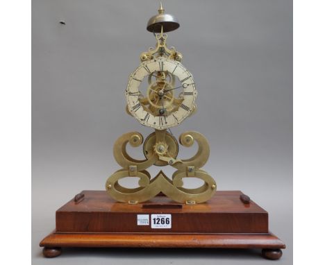 A brass skeleton mantel clock, 20th century of typical open frame form, with bell surmount, silvered chapter ring and a singl