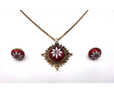 A 9ct gold, red and white enamelled pendant, decorated with a central flowerhead on a red enamelled ground, with a 9ct gold f