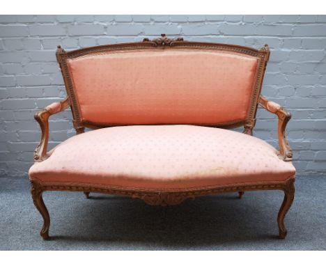 A Louis XV style carved walnut salon suite, to comprise; a sofa 125cm wide x 99cm high, a pair of armchairs, each 63cm wide x