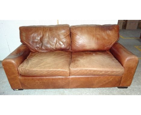 A brown aniline leather three seater sofa, raised on wooden square feet, 196cm wide.  BAY 1