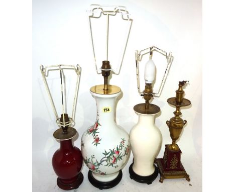 A 20th century Chinese baluster lamp decorated with fruit, a white glazed baluster lamp, a smaller red glazed lamp and a Rege