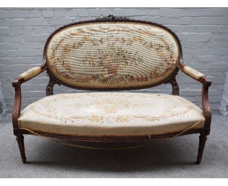 A Louis XVI style carved and stained beech salon suite comprising; a sofa, 140cm wide x 107cm high, three armchairs 63cm wide