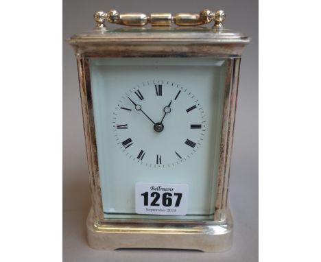 A French silver plated brass cased carriage clock, early 20th century, with white enamel dial, visible escapement and two tra