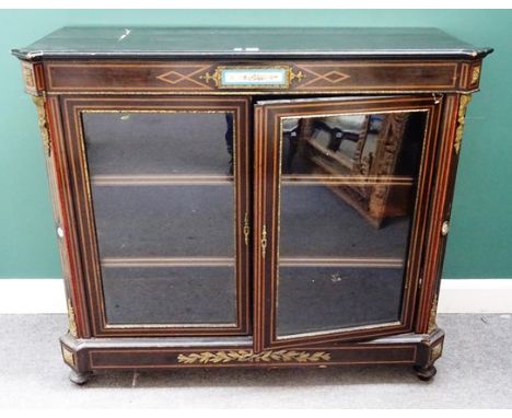 A mid-Victorian gilt metal and ceramic mounted ebonised glazed two door display cabinet, 127cm wide x 110cm high x 45cm deep.