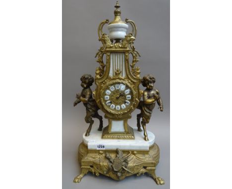 A Louis XVI style gilt metal and white marble mantel clock, 20th century, the lyre shaped body flanked by anthropomorphic fig