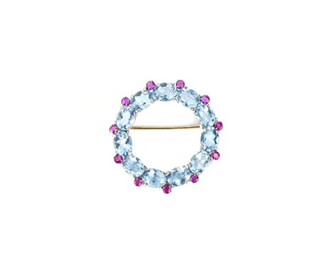 A ruby and aquamarine brooch, in an openwork circular design, mounted with oval cut aquamarines and with smaller circular cut