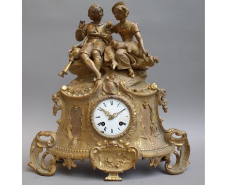 A Louis XVI style gilt metal figural mantel clock, 20th century, surmounted by gallant and companion over a white enamel dial