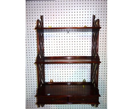A 20th century mahogany fret cut three tier hanging wall shelf with two short drawers, 49cm wide x 90cm high.   C10