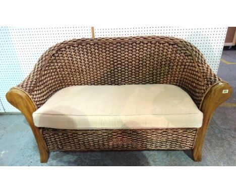 A 20th century mahogany framed rattan two seat sofa on block supports, 109cm wide x 179cm high.  BAY 3