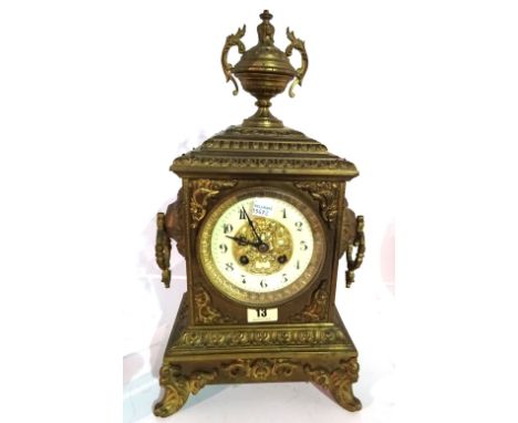 A late 19th century French 8 day metal cased clock, 40cm high with urn finial.   I4